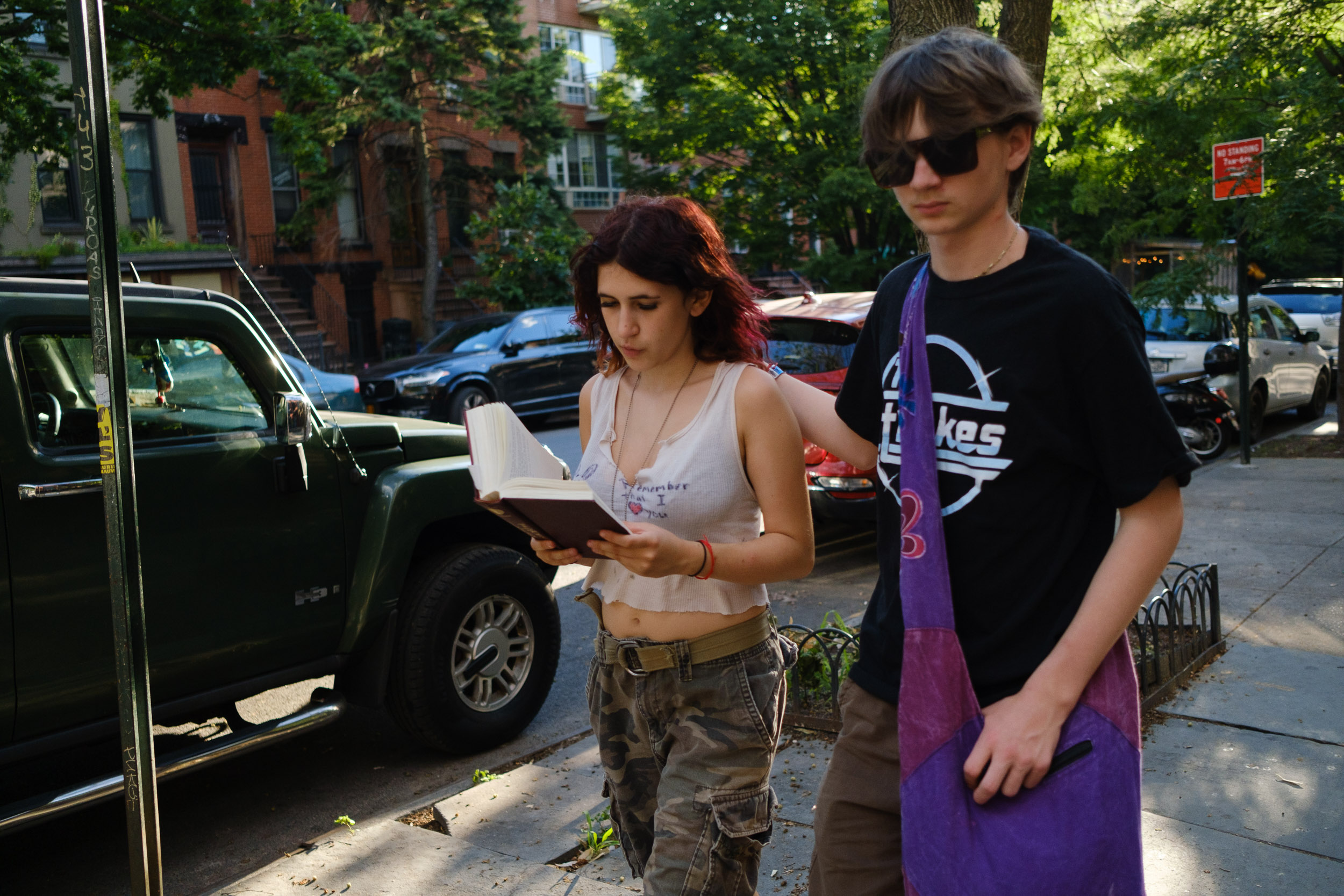 Hipster couple walking together while reading Park Slope Brooklyn New York