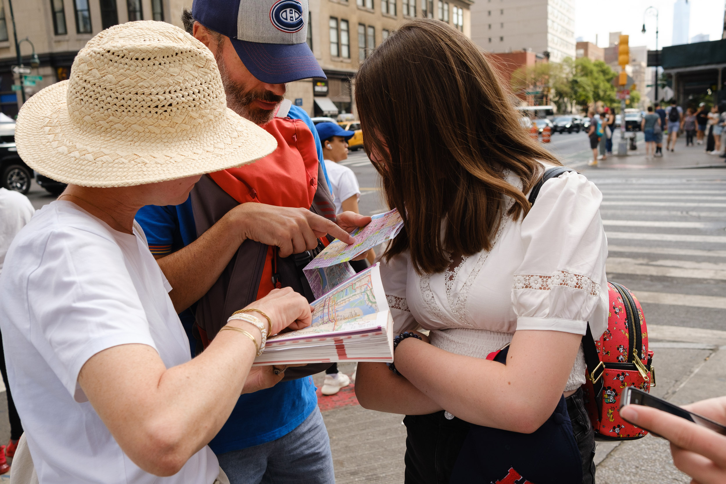 group of people reading tour guide book in NYC New York City