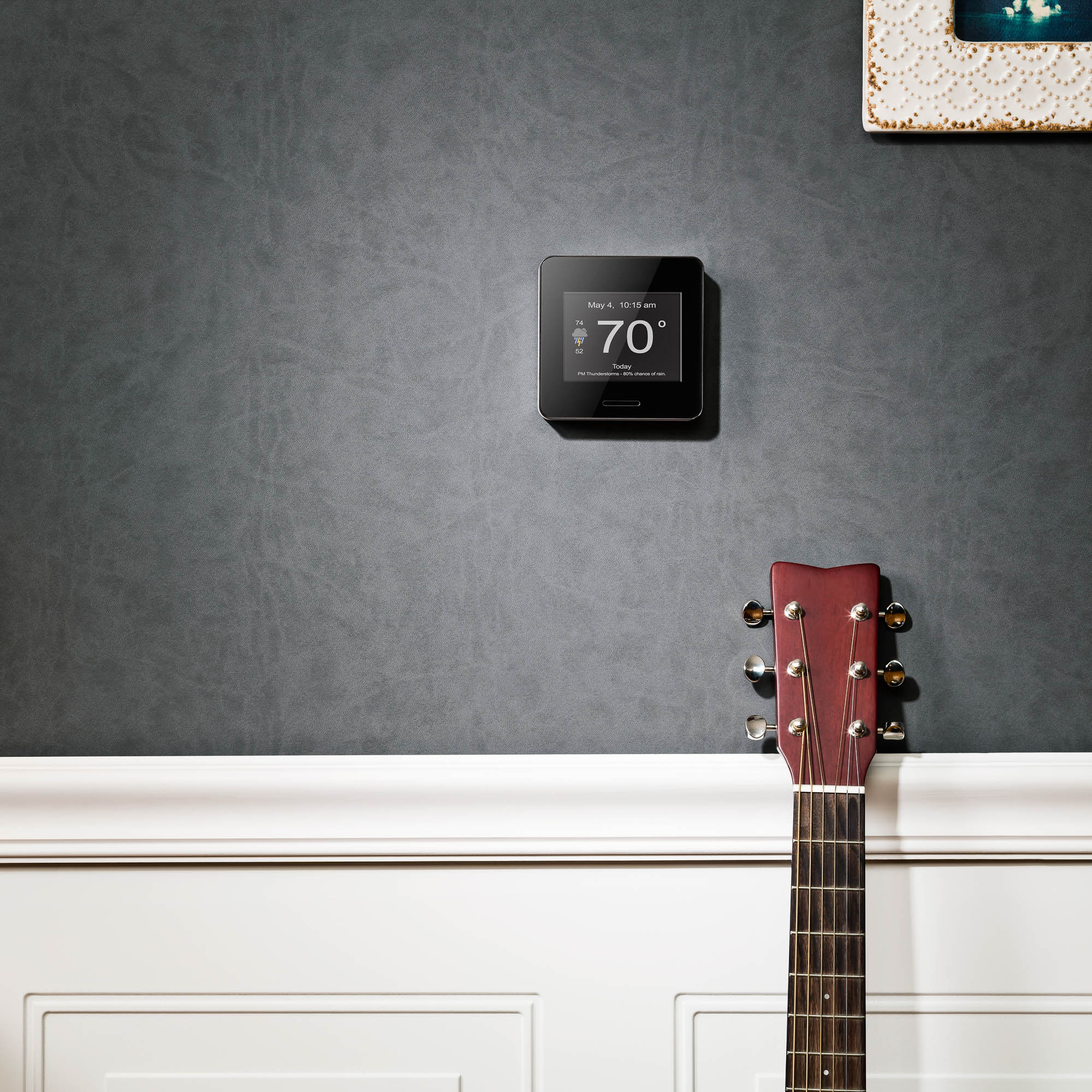 lifestyle product photographer photography of wifi weather station in living room with guitar 
